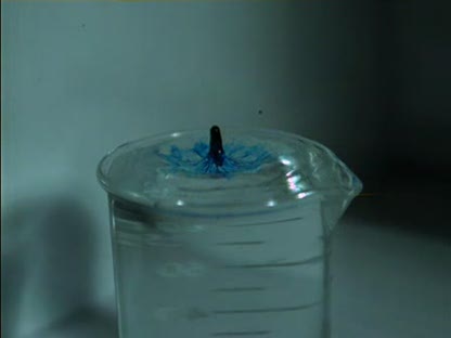 Blue dye drop into water